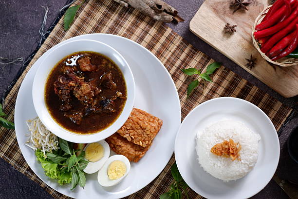 istock Rawon is an Indonesian beef soup. Originating from East Java, rawon utilizes the black keluak nut as the main seasoning, which gives a dark color and nutty flavor to the soup. Nasi Rawon, telur asin 2206115541