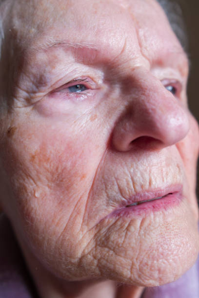 istock Senior woman crying with tear rolling down her face 2206116055
