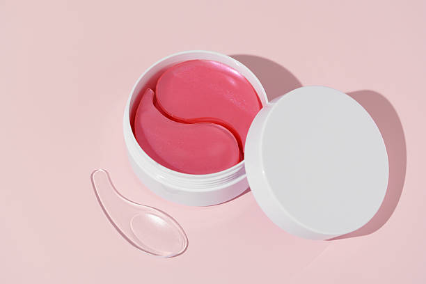istock A white mock-up jar with pink hydrogel eye patches and a spatula on a pink background. Designed for deep hydration, wrinkle reduction, skin firming, and dark circle correction. 2206118513