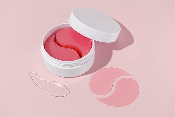 istock White jar with hydrogel patches and spatula and sample on pink isolated background. Concept of women's beauty products for facial care, dark circles reduction 2206118516