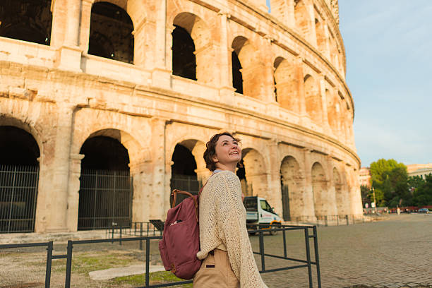 istock Woman looking with awe at Colosseum in Rome 2206119618