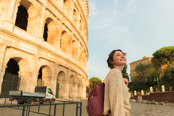 istock Woman looking with awe at Colosseum in Rome 2206119622