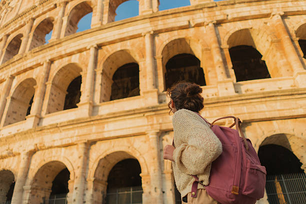 istock Woman looking with awe at Colosseum in Rome 2206119624
