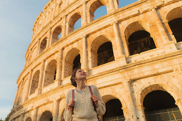 istock Woman looking with awe at Colosseum in Rome 2206119636