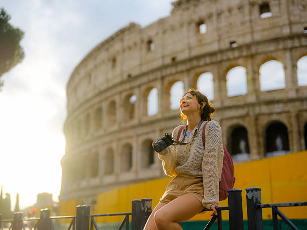 istock Woman looking with awe at Colosseum in Rome 2206120433