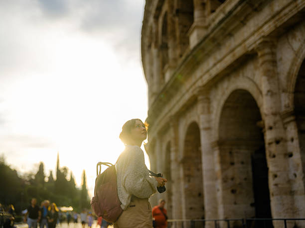 istock Woman looking with awe at Colosseum 2206120471