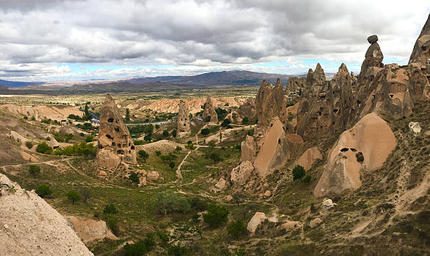 Rocky terrain with unique formations under moody clouds and misty ambiance