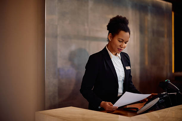 istock Black female hotel manager working at reception desk. 2206124270