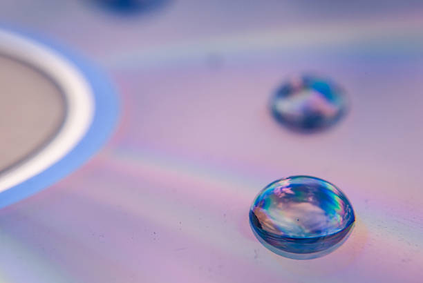 Water drops on blue background, top view