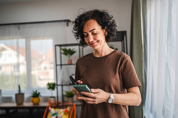 istock woman hold two mobile phones, use wireless connection technology 2206126570