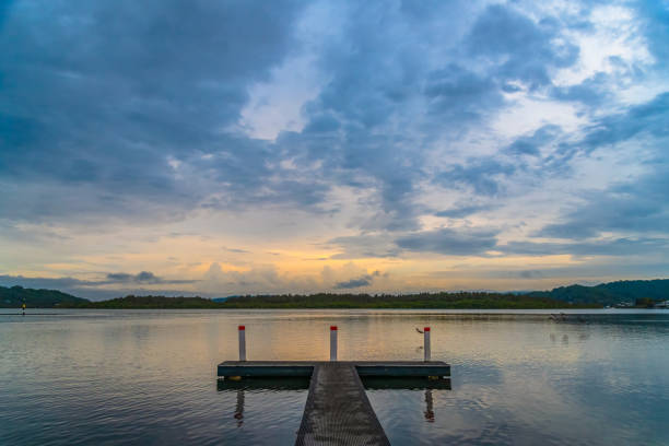 Sunrise over the bay with rain clouds at Woy Woy on the Central Coast, NSW, Australia.