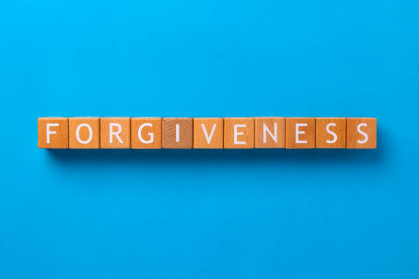istock Block Words with Forgiveness on a Blue Background 2206126625