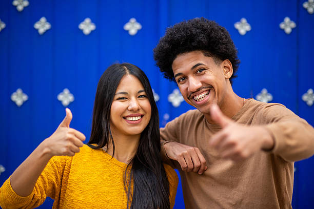 istock cheerful smiles and thumbs-up gestures 2206127509