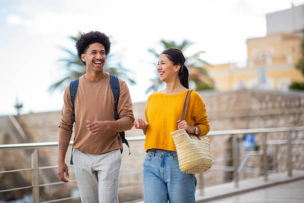 istock Two friends walking together outdoors 2206127514