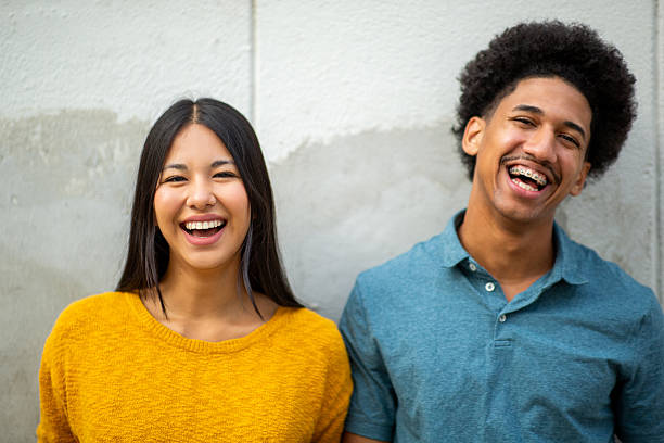 istock Close up happy young couple laughing by wall 2206127528