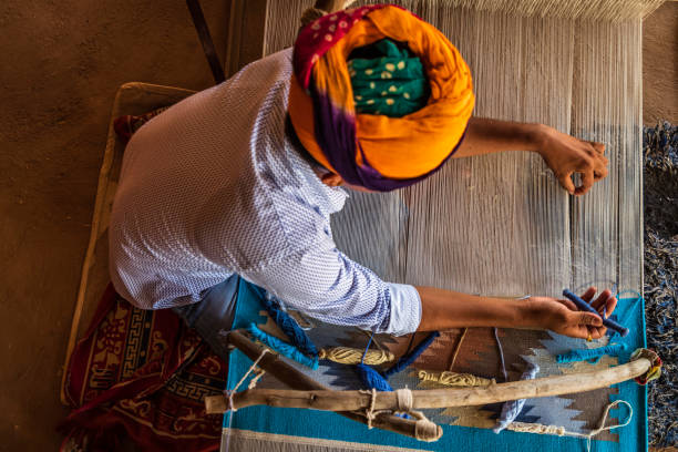istock Indian man weaving textiles (durry) in Rajasthan 2206129242
