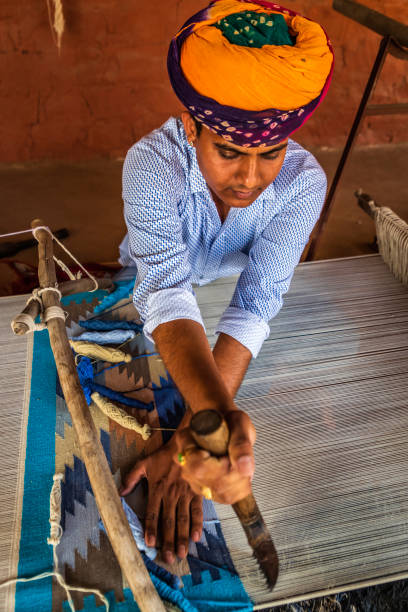 istock Indian man weaving textiles (durry) in Rajasthan 2206129335