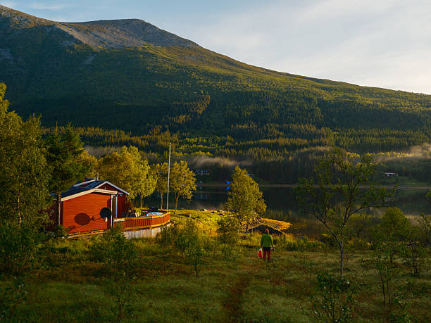 Serene man  going fishing in Norwegian backcountry in summer
