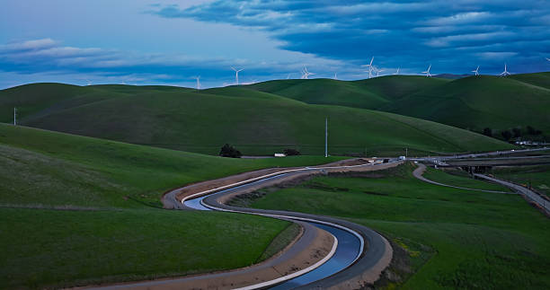 istock Aqueduct Tributary Curving Towards Altamont Pass Windmills 2206136563