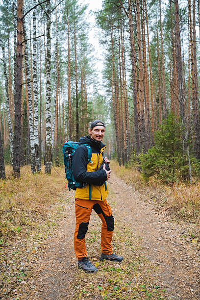 istock Adventurous Hiker in a Serene Forest Trail with a Backpack 2206139975