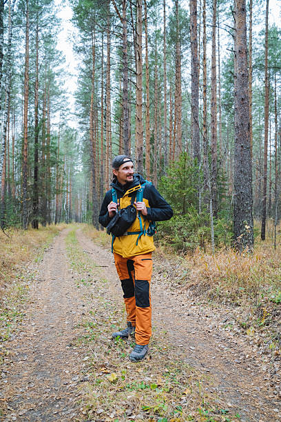 istock An Adventurous Hiker Is Exploring a Serene and Tranquil Forest Path While Wearing Vibrant and Stylish Outdoor Gear to Fully Enjoy Nature 2206139985
