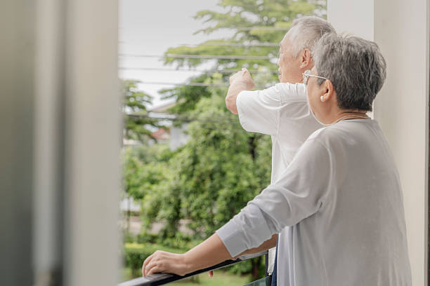 istock Two elderly individuals enjoy a light-hearted conversation and laughter on a balcony, sharing a peaceful and joyful moment in a relaxed outdoor setting, highlighting friendship and companionship. 2206143754