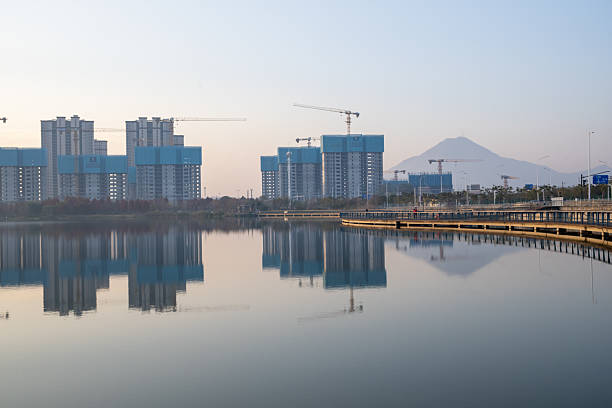 Hoisting on scaffolding at a residential building construction site in a developing city in Fujian Province, China
