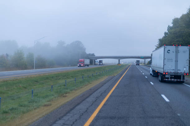 istock Semi-truck traveling on foggy highway. 2206146607