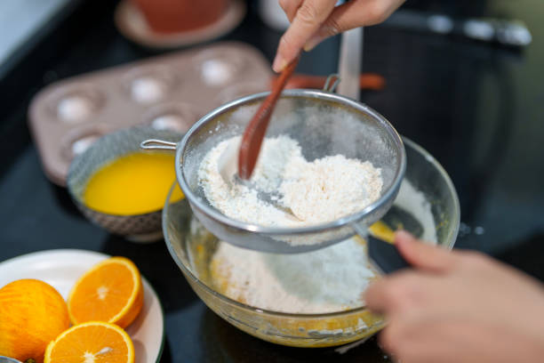 istock Sifting Flour for Homemade Orange Muffins 2206150831