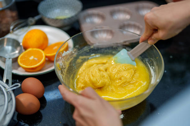 istock Mixing Fresh Orange Batter for Homemade Muffins 2206151567