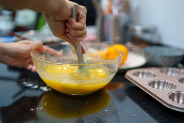 istock Mixing Fresh Orange Batter for Homemade Muffins 2206151712