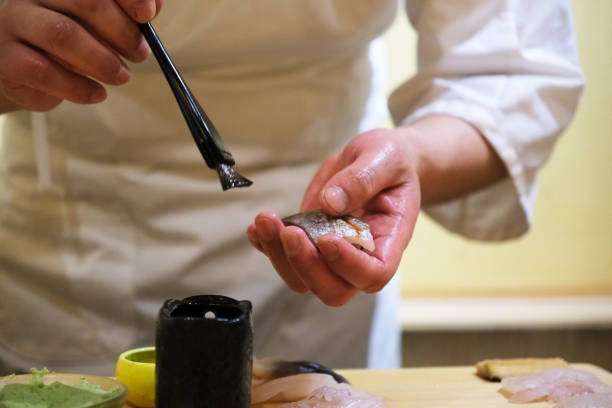 istock chef hand making Sushi, traditional Japanese food 2206155213