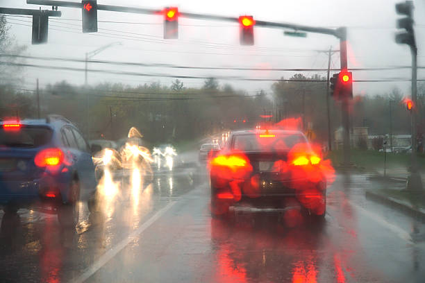 istock blurred street scene through car windows with rain drop 2206155336