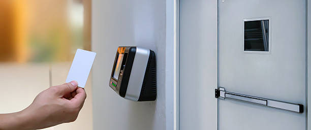 istock Proximity card reader door unlock, Close up hand of security man using ID card to scanning at the access control system for identity verification to open the door exit or fire escape or check attendance. 2206157987