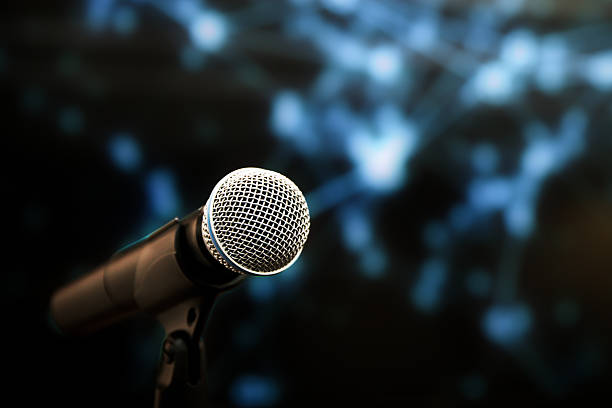 istock Microphone Public speaking backgrounds, Close-up the microphone on stand for speaker speech presentation stage performance with blur and bokeh light background. 2206157996