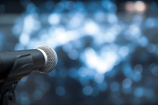 istock Microphone Public speaking backgrounds, Close-up the microphone on stand for speaker speech presentation stage performance with blur and bokeh light background. 2206157997