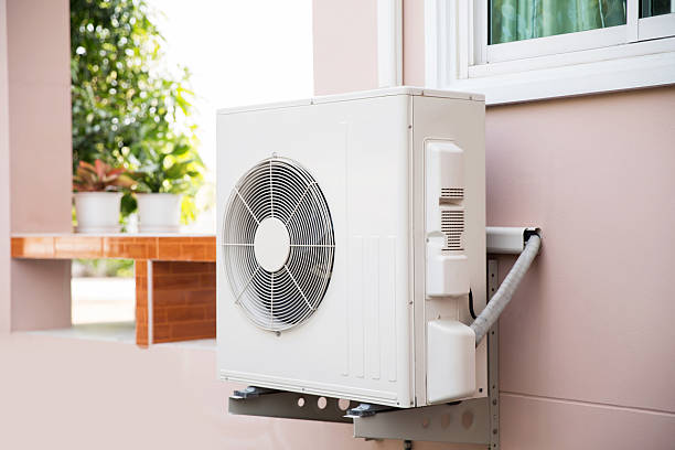 istock Air compressor, Close-up external split wall type of outdoor home air conditioner unit installed on outside building. Concepts of cool or heat or hot and air conditioning system maintenance. 2206158079