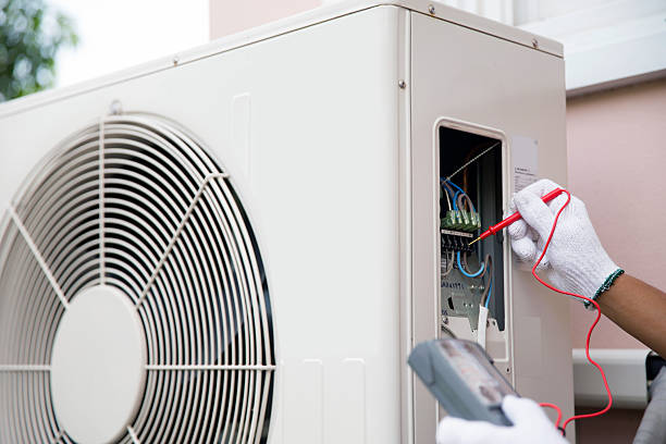 istock Technician using measuring equipment checking electric at circuit breaker on outdoor air compressor unit after install and check refrigerant air conditioning system maintenance. 2206158085