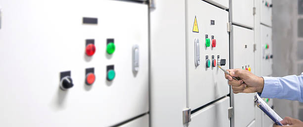 istock Electricity and electrical maintenance service, Engineer checking air handling unit AHU starter button control panel and hvac system of air conditioner load center cabinet for maintenance. 2206158107