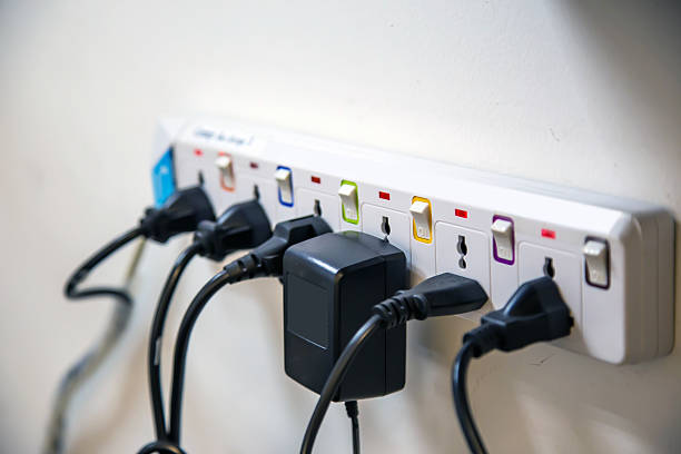 istock Old and damaged electric adapter power plug has many appliances are plugged outlet socket concept of risk danger overloaded current electrical. 2206158223