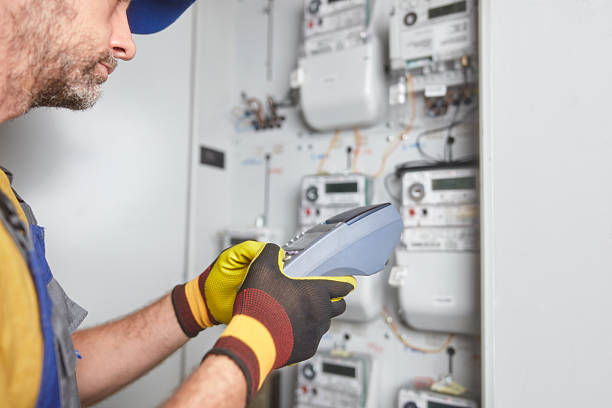 istock Technician reading consumption and charging on a wireless electricity power meter station in a building. 2206165564