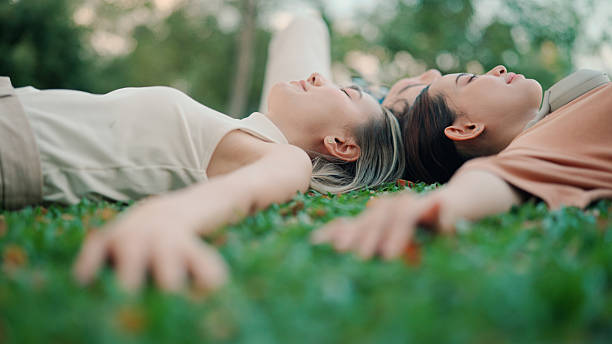 istock Asian friends lying down and resting in public park 2206167288