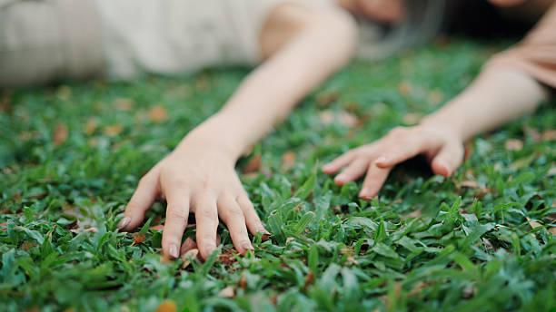 istock Asian friends lying down in public park 2206167344