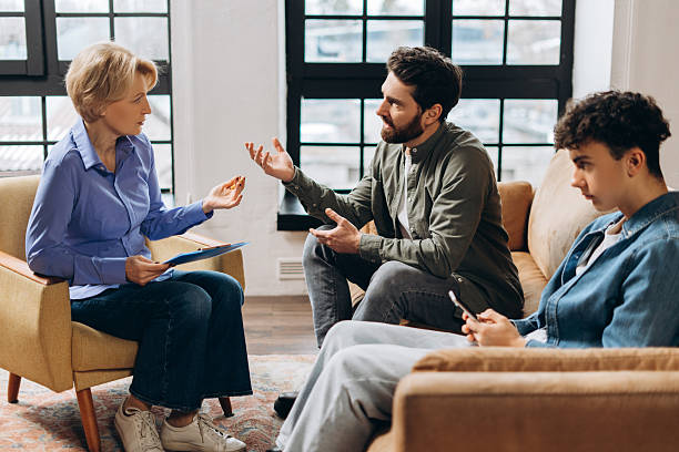 istock Emotional father talking with psychotherapist about his son at therapy session 2206169291