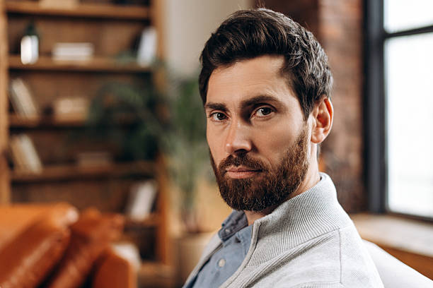 istock Successful bearded middle aged Hispanic man looking at camera in office 2206169339