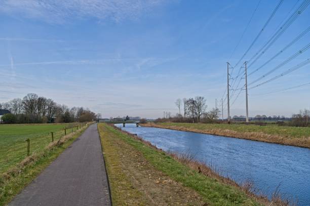 istock Row of high-voltage masts along the river Aa Strang 2206169794