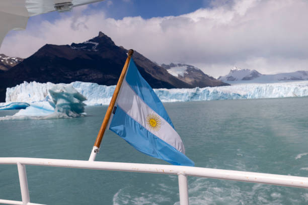 Argentine flag flies on bow of ship over Perito Moreno glacier