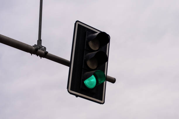 istock Traffic light with green signal against cloudy sky 2206175136