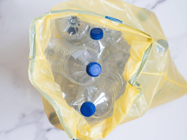 istock Plastic bottles inside yellow trash bag awaiting recycling 2206175813