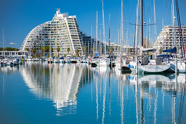Sailboats in the Marina and the Iconic Pyramid shaped buildings of the village of LGM on the Mediterranean Sea